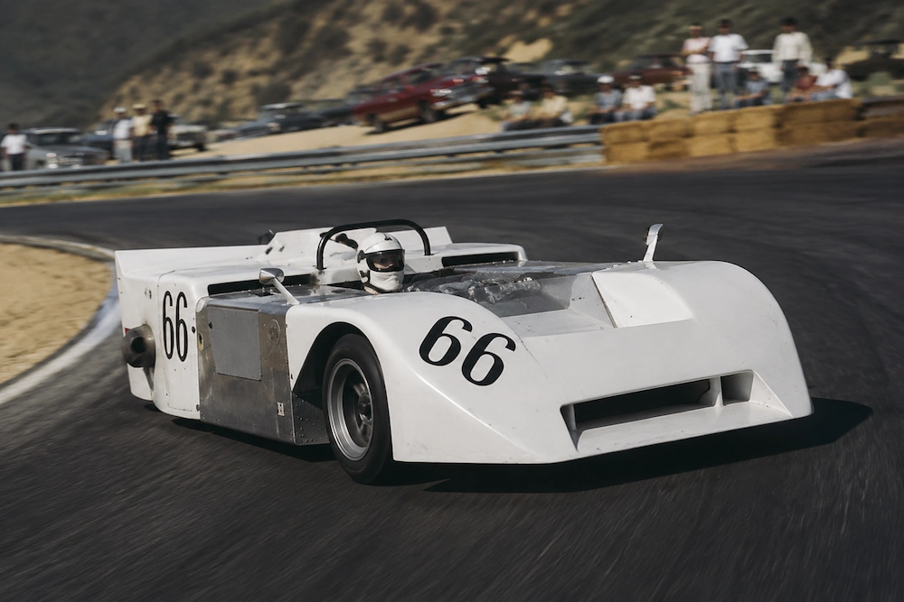 Chaparral 2J fan car racing through a Canadian circuit corner with rear suction fans and a bold white aerodynamic body.